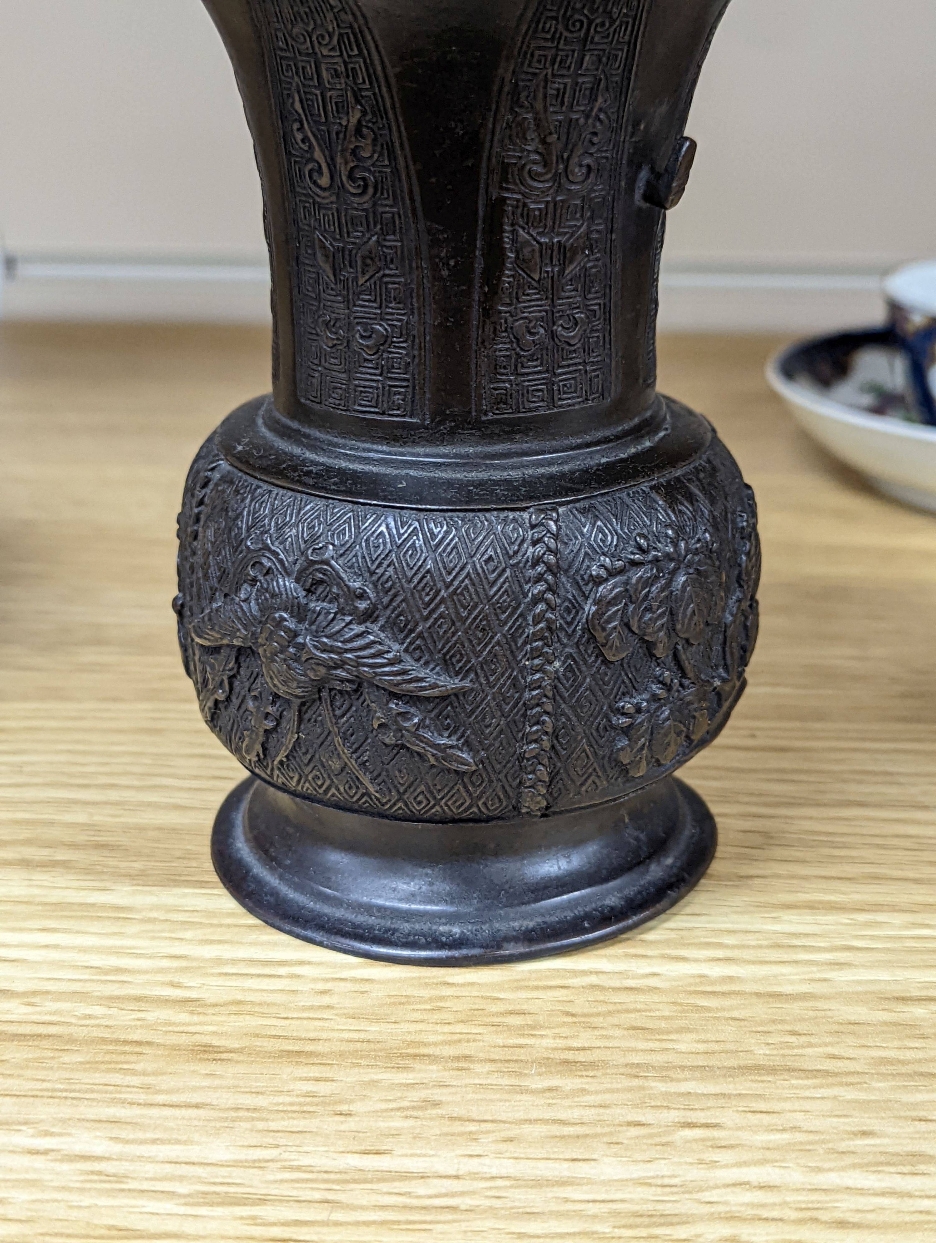 A pair of Japanese Meiji period bronze ‘dragon’ bottle vases and another, 21cm